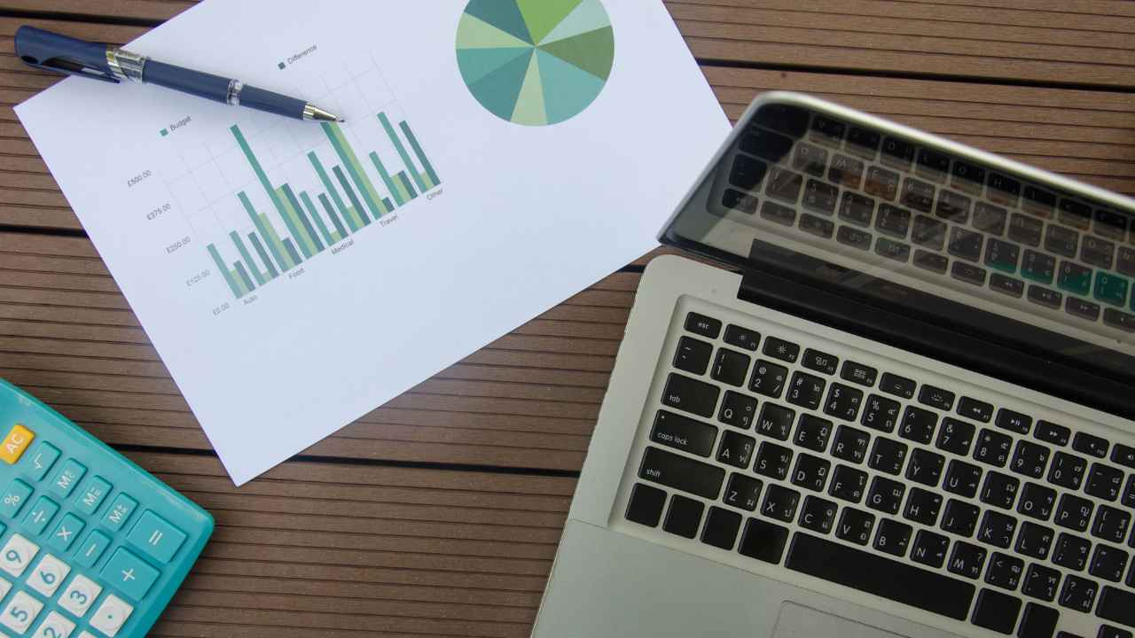 A laptop and pen on a table