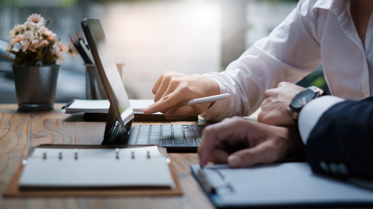 A person pointing at a computer