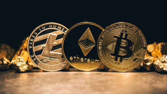 gold coins, each with a logo of popular cryptocurrencies