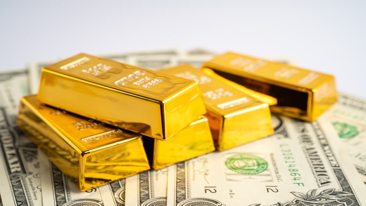 gold_stacks_on_dollars_width_1200_format_JPEG.jpg