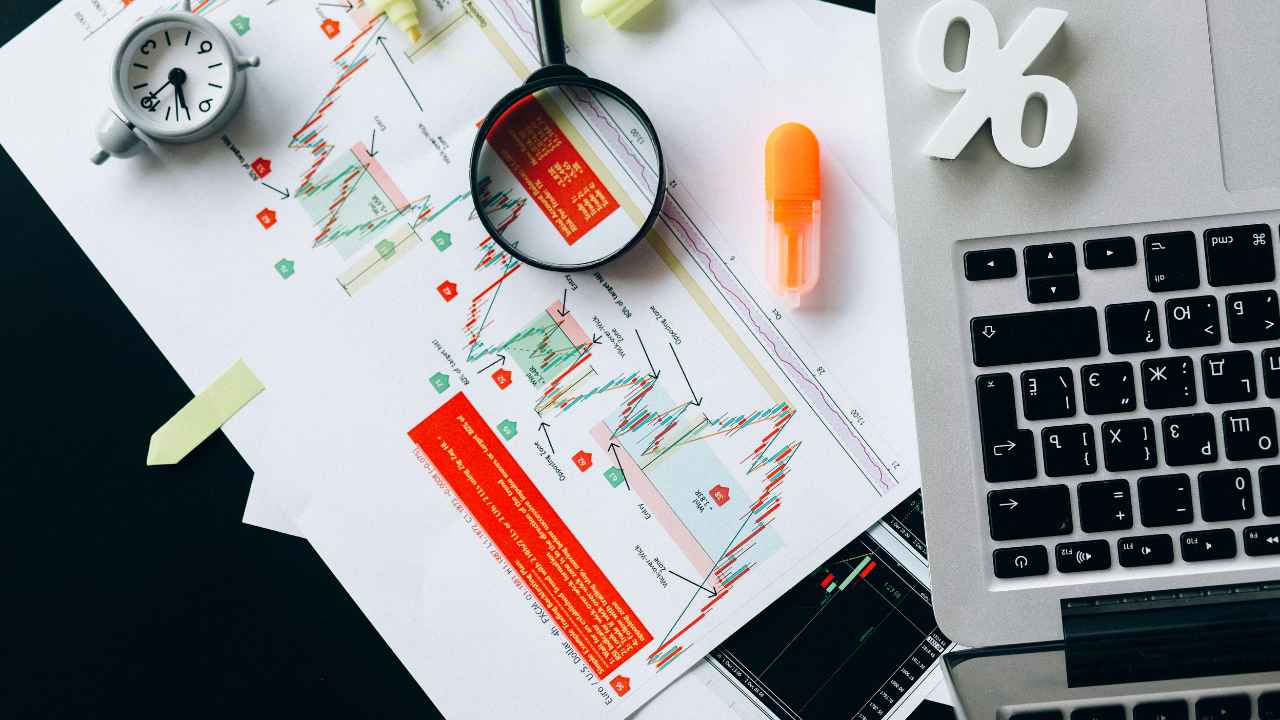 A laptop and a magnifying glass on a table