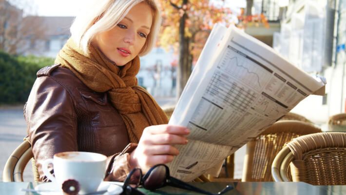  A woman reading the business newspaper