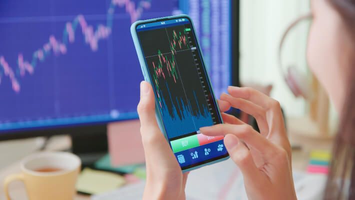 close-up of a smartphone displaying stock market charts