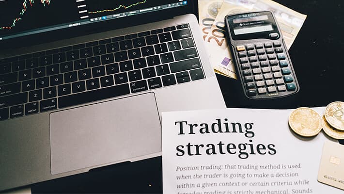 laptop, sterling and calcutor with trading strategies notes